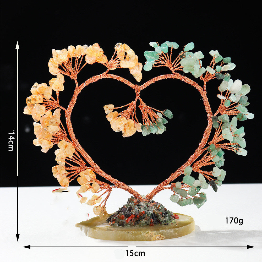 Decorative heart-shaped sculpture with floral elements on a black background