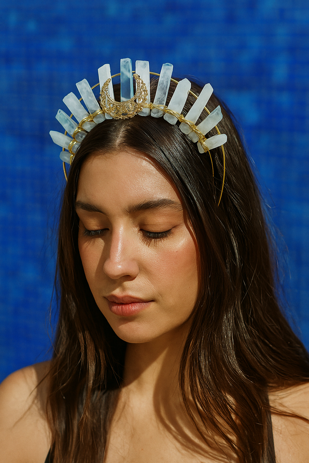 Woman wearing a decorative headpiece against a blue background