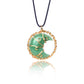 Green crescent moon pendant with gold wire wrapping on a black cord against a white background