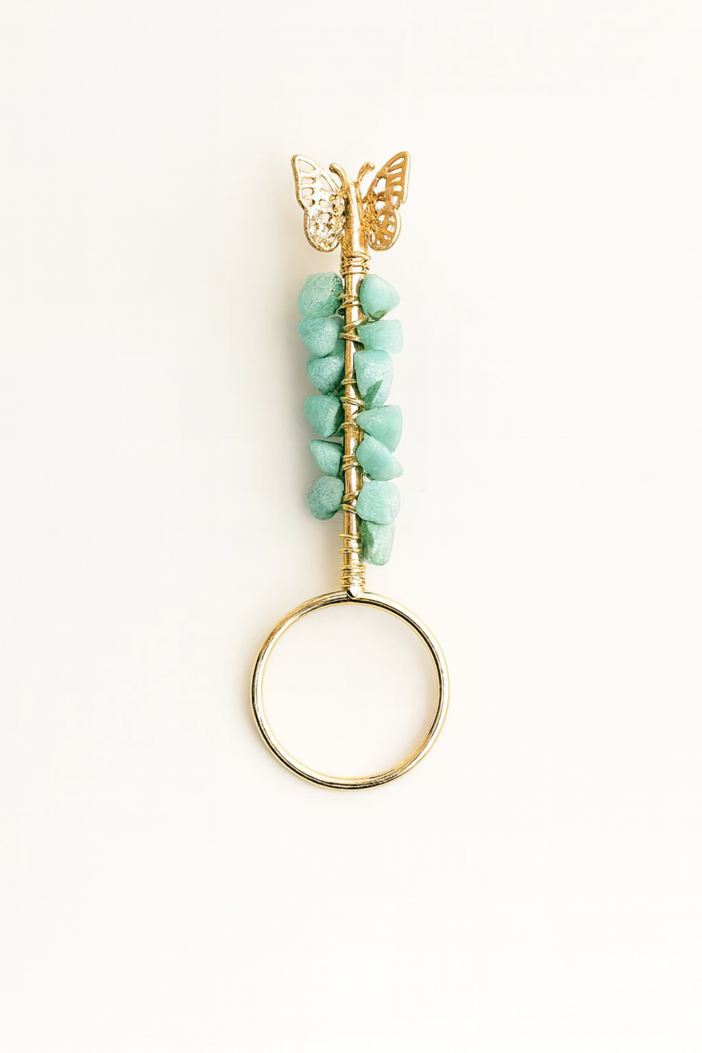 Jewelry with turquoise stones and a gold butterfly on a white background