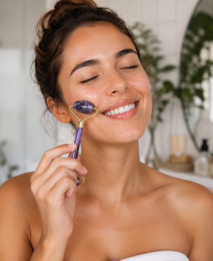Woman using a purple facial roller on her face in a home setting