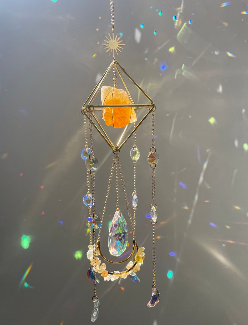 Decorative crystal hanging with colorful beads against a dark background