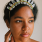 Woman wearing a crystal headband with a neutral background