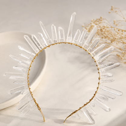 Clear crystal headband with gold accents on a neutral background