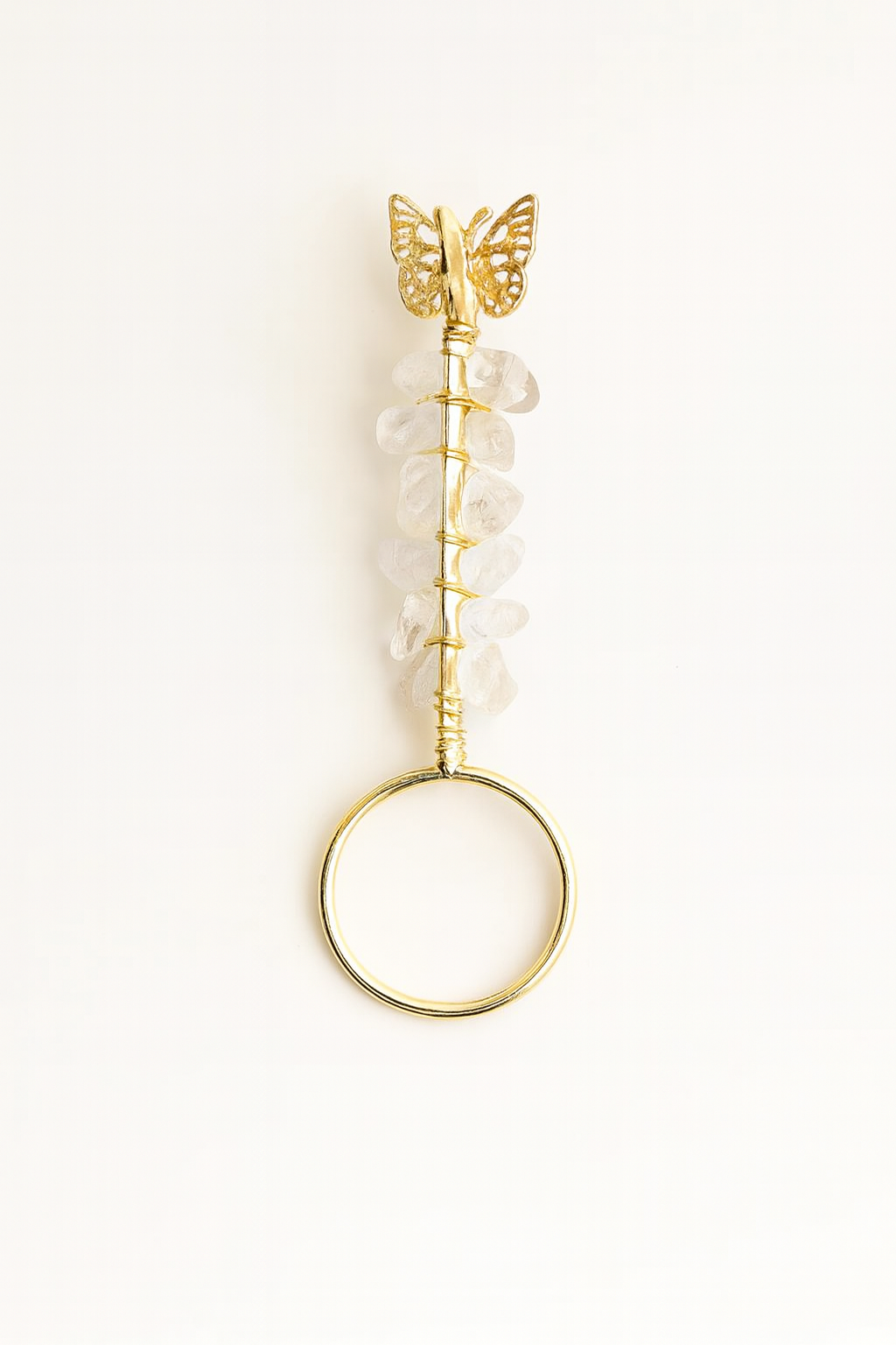 Gold hairbrush with butterfly design on a white background