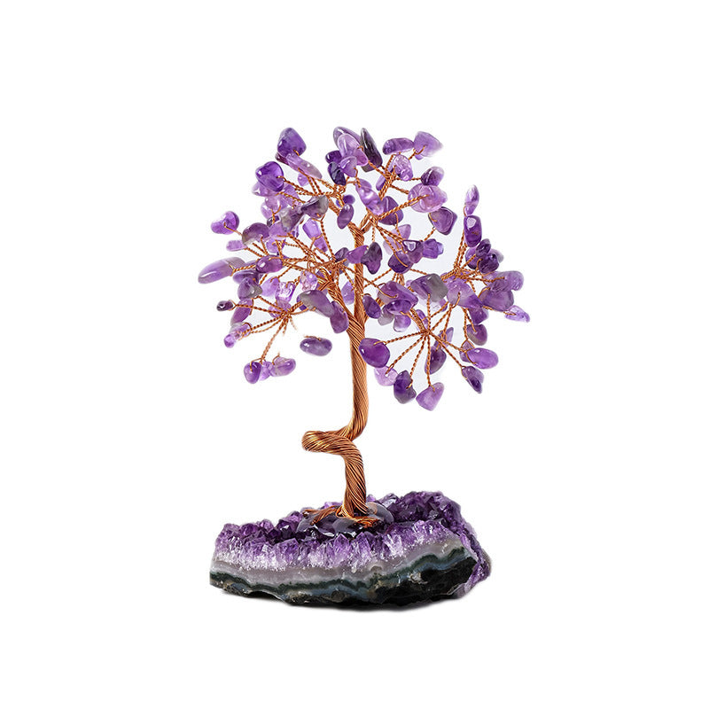 Amethyst crystal tree on a purple crystal base with a white background
