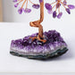 Amethyst crystal tree on a purple crystal base with a white background