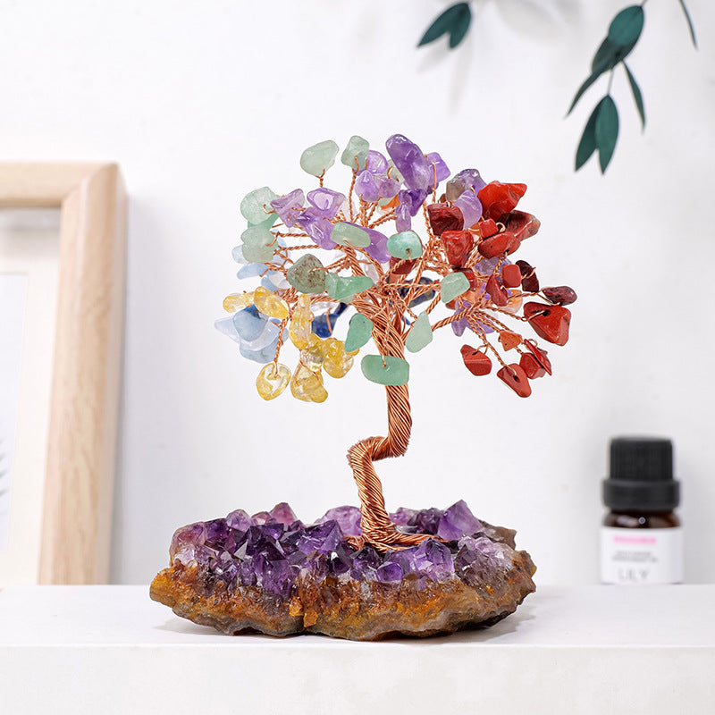 Colorful crystal tree on a rock base with a white background