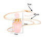 Pink bottle-shaped pendant on a gold chain with measurements indicated