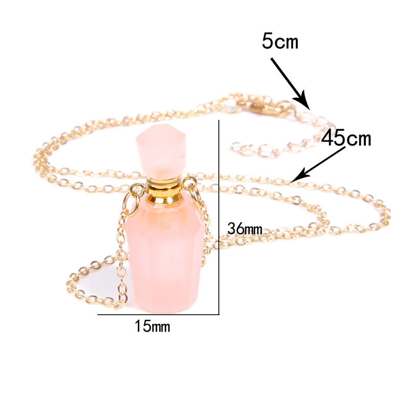 Pink bottle-shaped pendant on a gold chain with measurements indicated