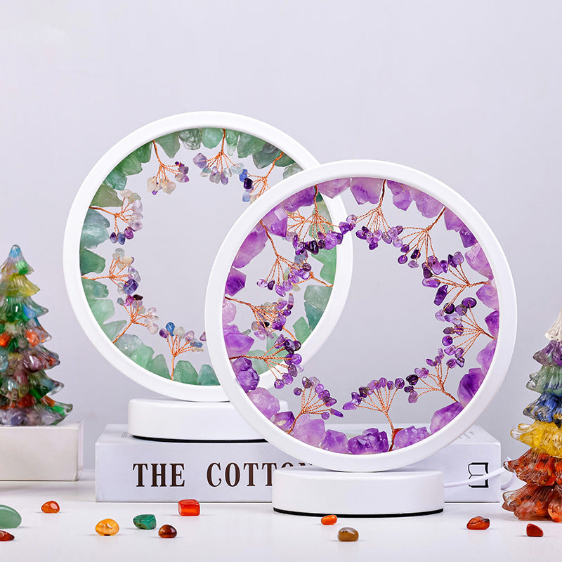 Two circular coasters with floral designs on a white surface with decorative items.