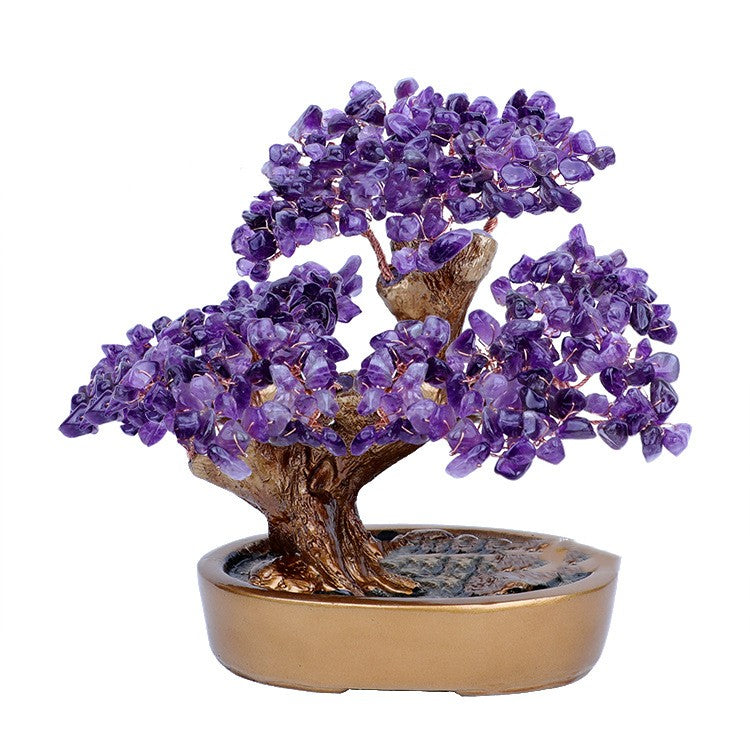 Decorative purple crystal bonsai tree on a white background