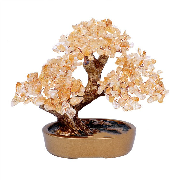 Decorative crystal bonsai tree in a gold pot on a white background