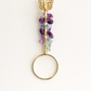 Jewelry holder with gemstones and gold accents on a white background