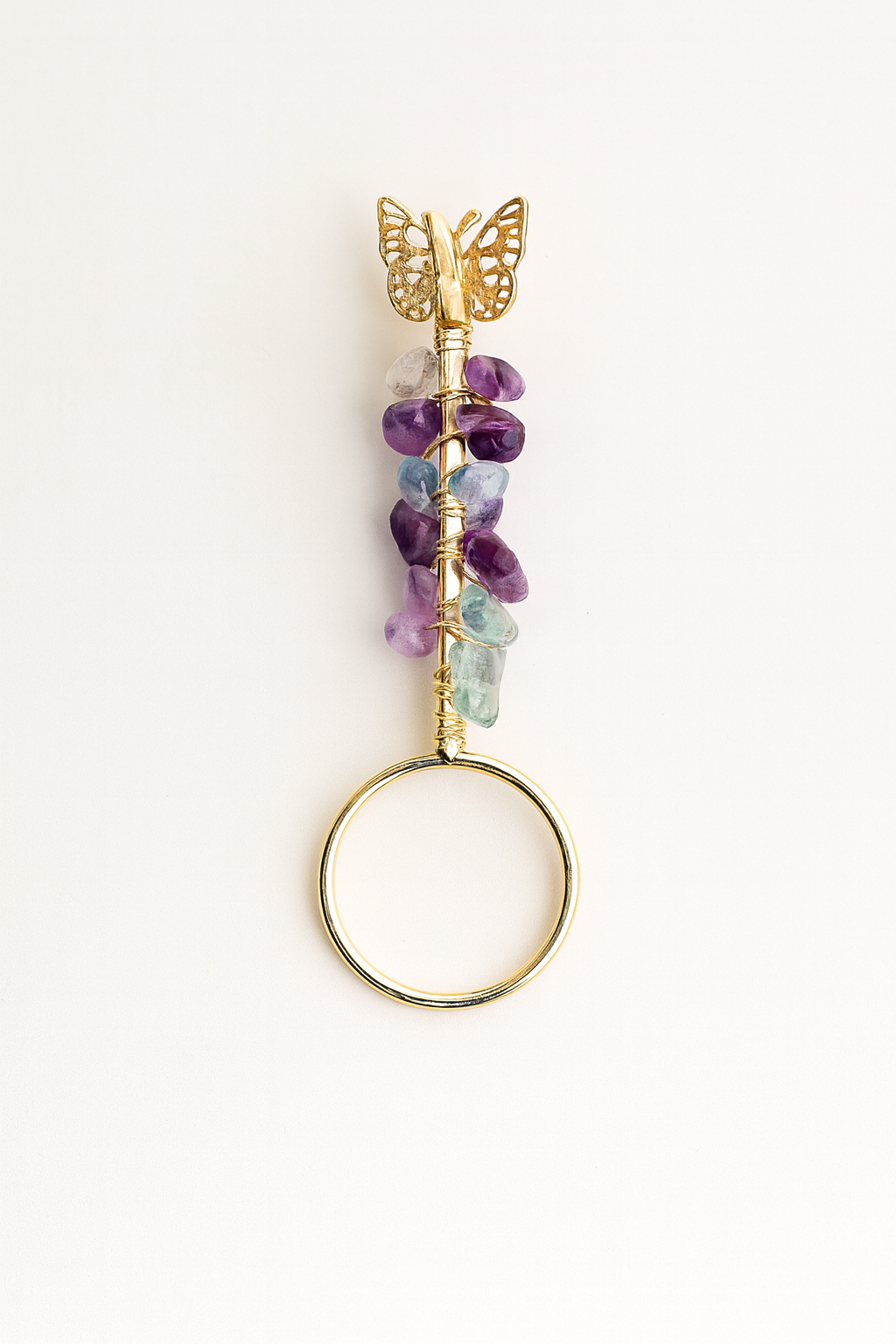 Jewelry holder with gemstones and gold accents on a white background