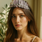 Woman wearing a crystal headband with a neutral background
