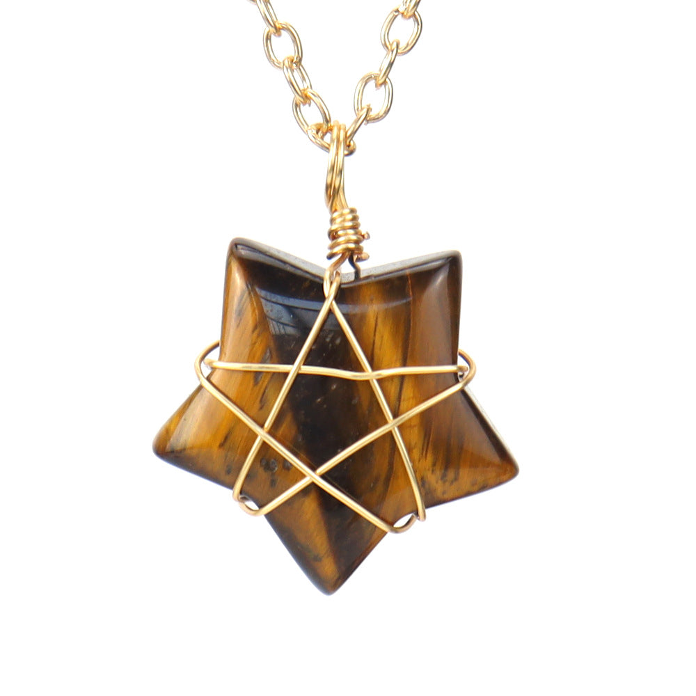 Star-shaped tiger's eye stone pendant with gold wire wrapping on a white background