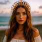 Woman with a decorative headpiece on a beach at sunset
