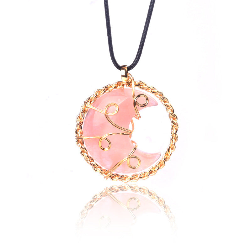 Pink moon-shaped pendant necklace on a white background