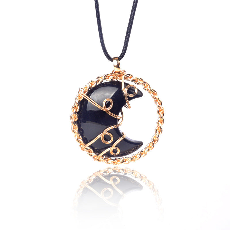 Black boot pendant with gold chain on a white background