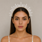 Woman wearing a crystal headband against a neutral background