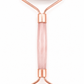 Rose quartz facial roller with rose gold accents on a white background
