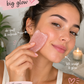 Woman using a pink facial brush with text highlighting benefits on a blurred background