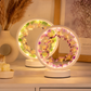 Decorative table lamps with floral designs on a wooden surface.