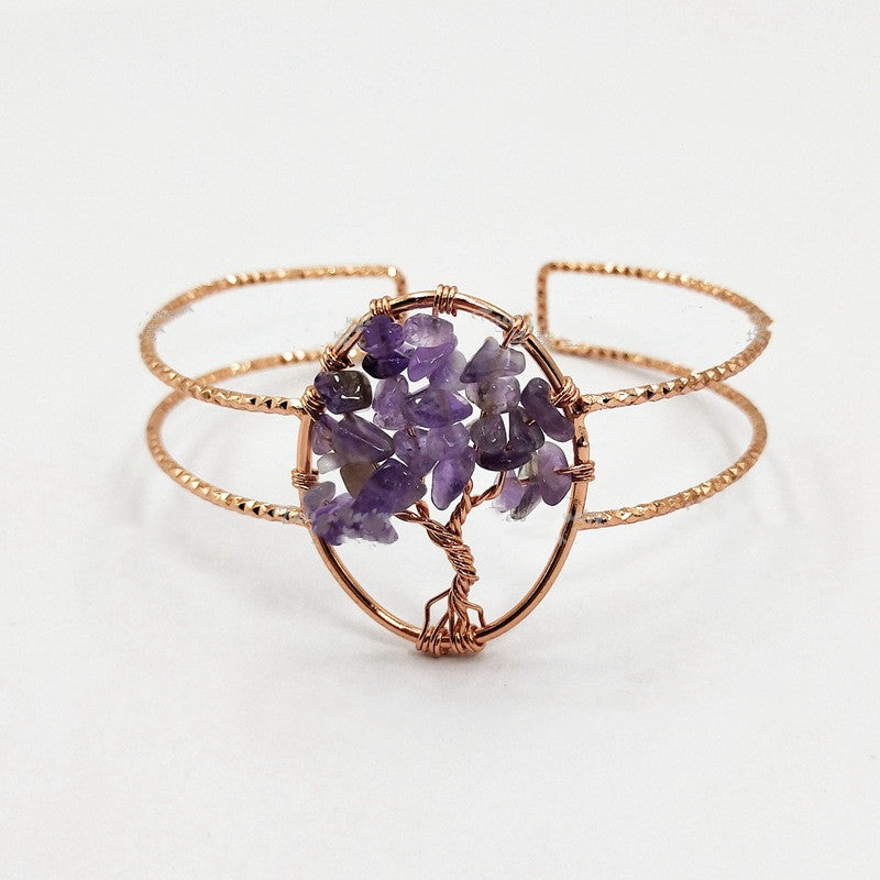 A rose gold wire-wrapped cuff bracelet featuring a central cluster of purple amethyst gemstones arranged in a tree-of-life pattern, shown on a clean white background.