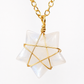 A gold chain necklace with a Star of Life pendant made from gold wire wrapped around a milky white, iridescent gemstone, shown on a plain white background.