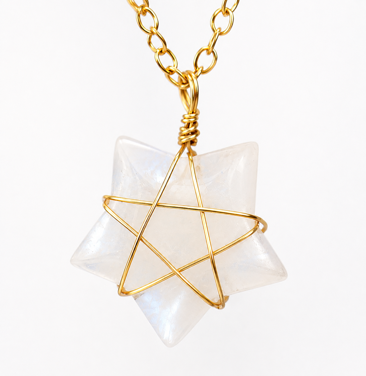 A gold chain necklace with a Star of Life pendant made from gold wire wrapped around a milky white, iridescent gemstone, shown on a plain white background.